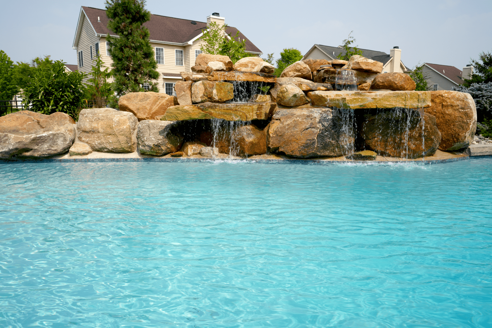 A pool with delightful water features, including a stunning waterfall.