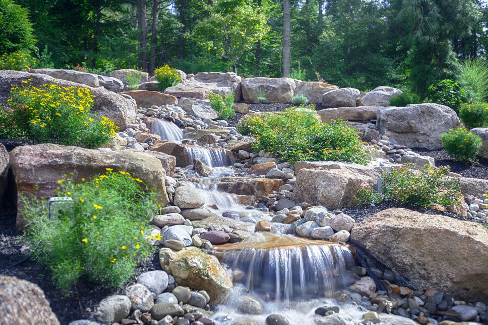 A small waterfall in a rocky area with water features.