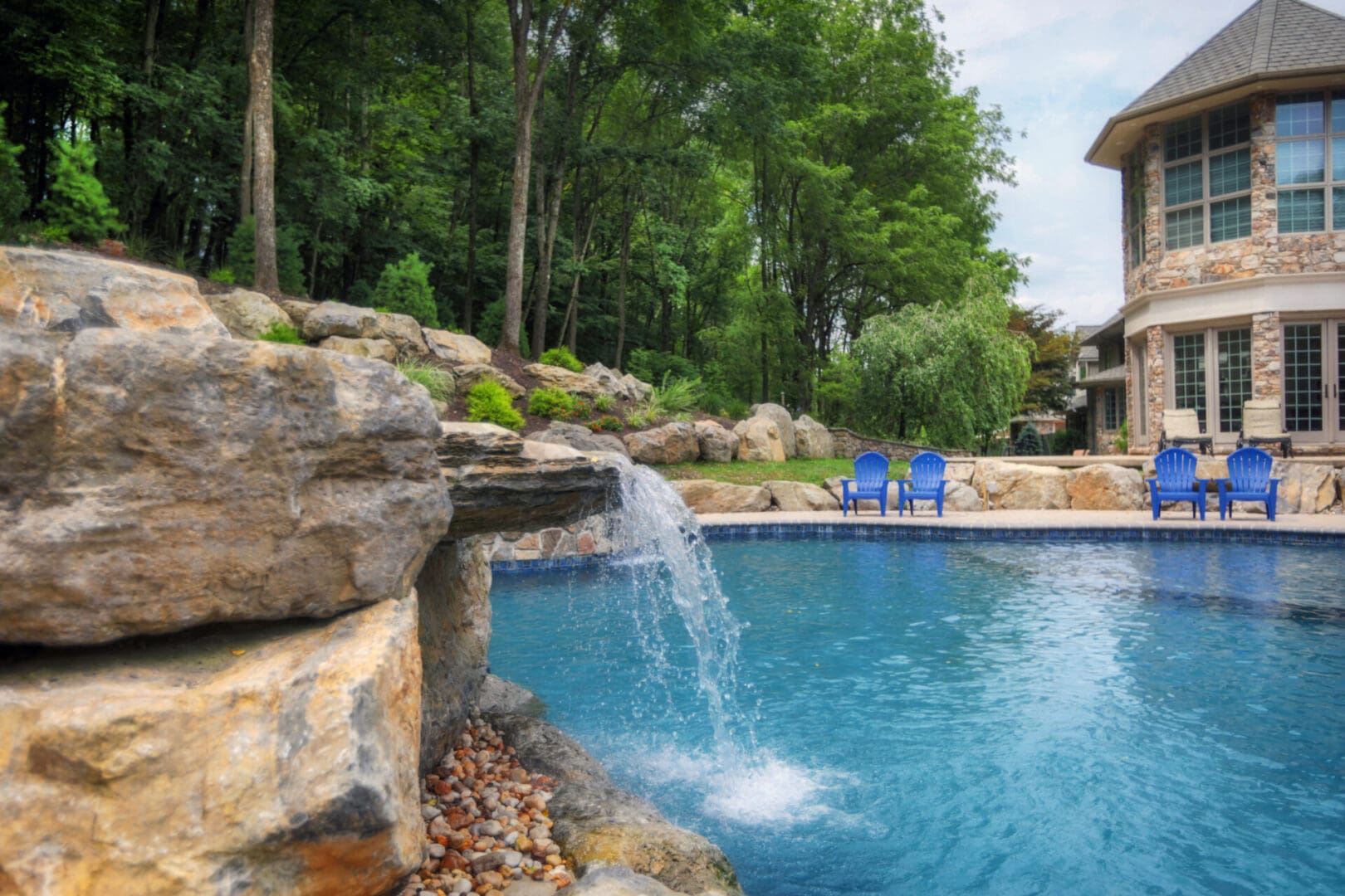 A pool with water features including a waterfall and rocks.