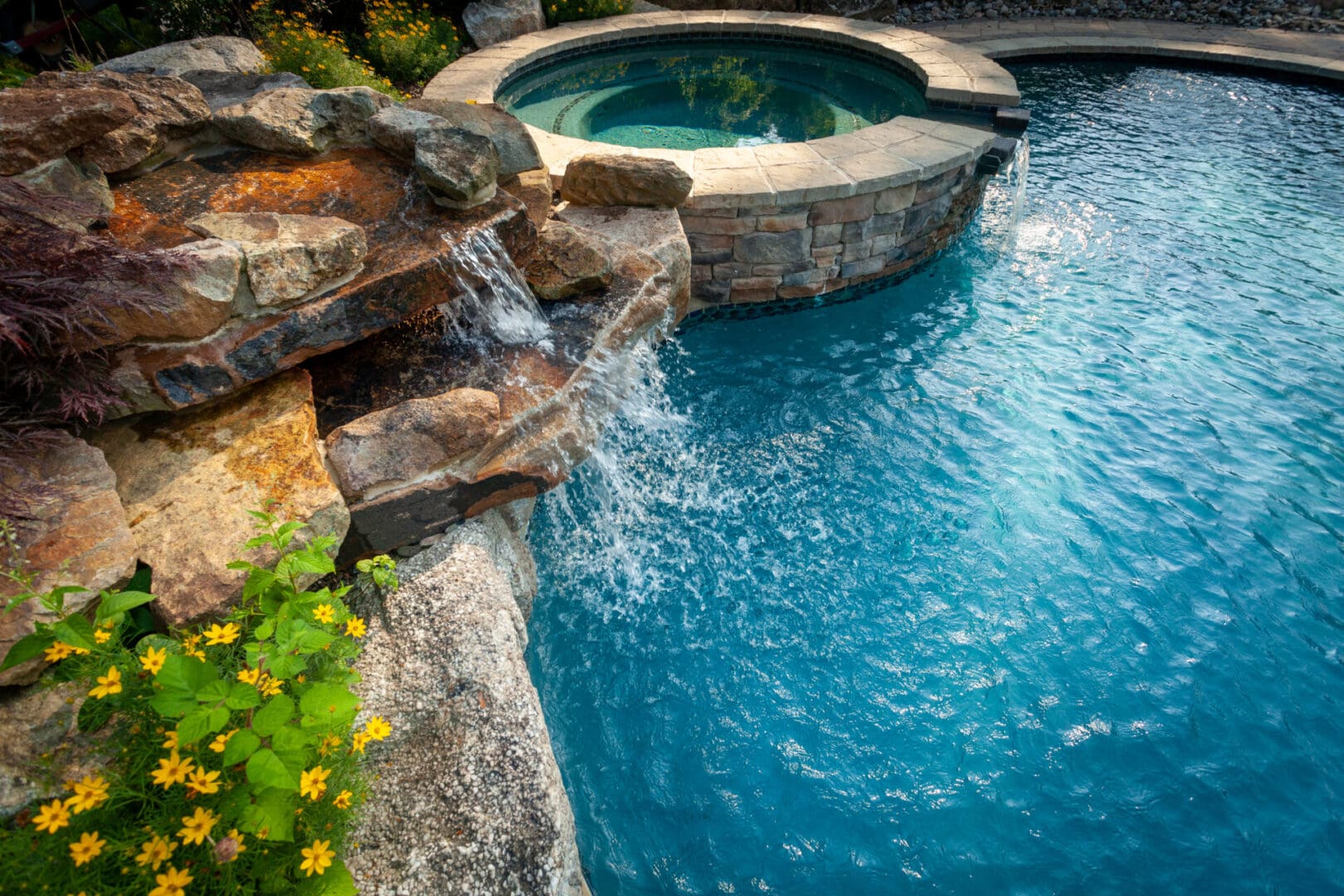 A pool with water features, including a waterfall and rocks.