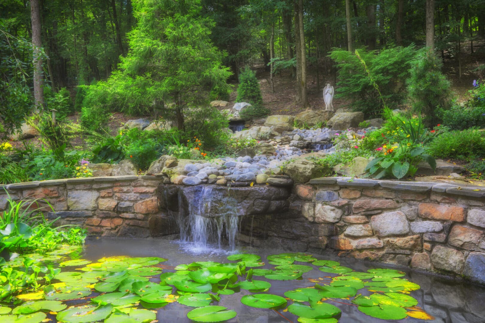 A forest pond with water features and lily pads.