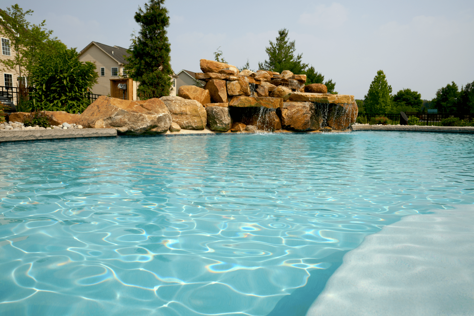A vibrant blue swimming pool with a modern pool design.