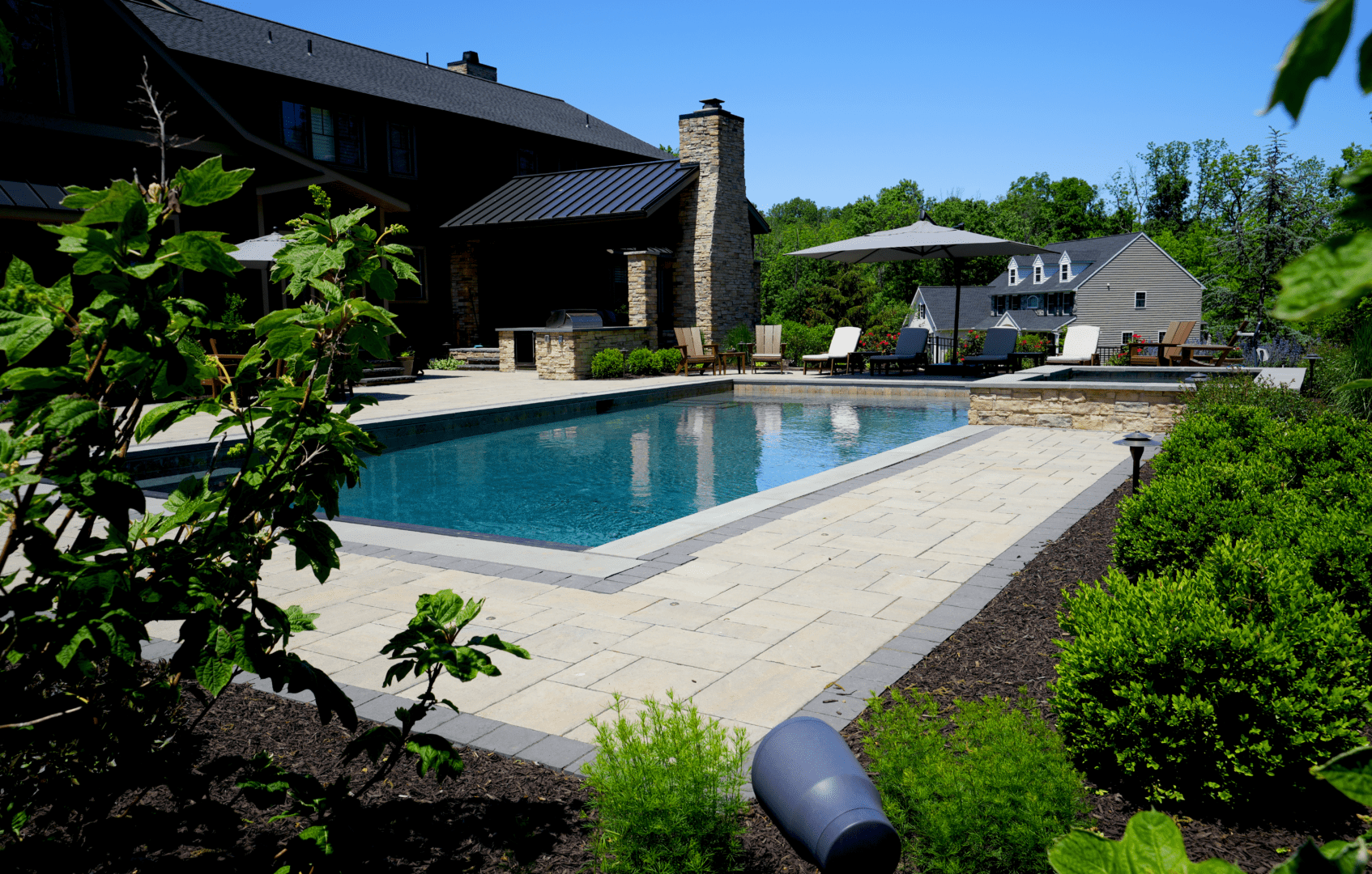 A beautifully designed swimming pool in the backyard of a house.