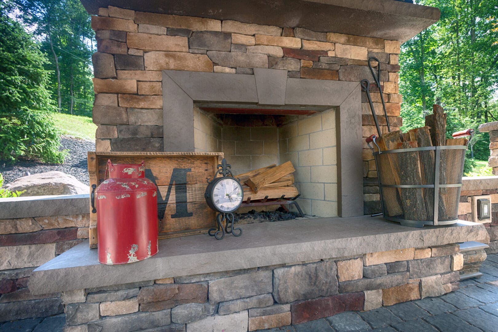 A stone fireplace with a custom fire pit on it.