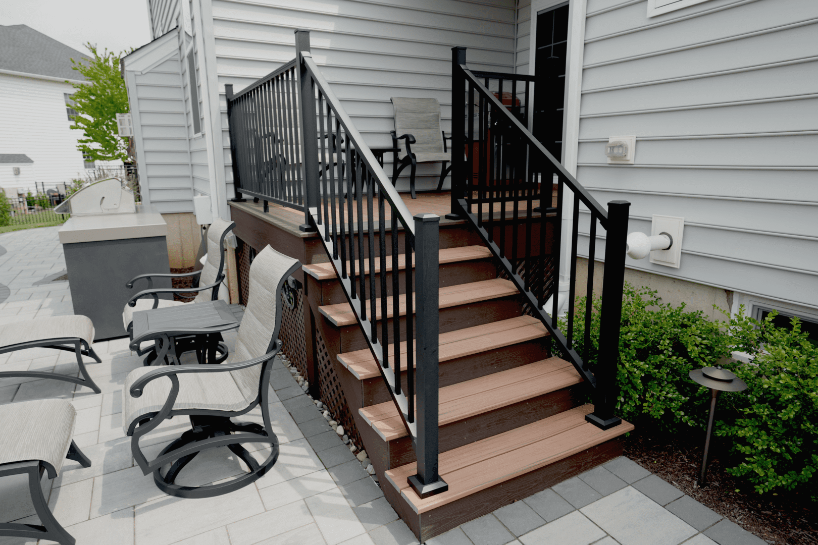 A patio with custom structures, including chairs and a stair railing.