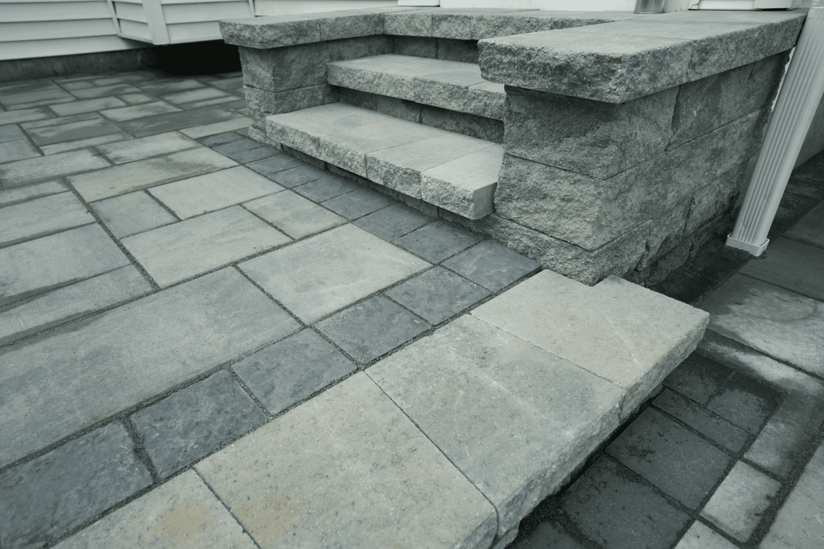 A black and white photo of a stone patio with hardscape design steps.