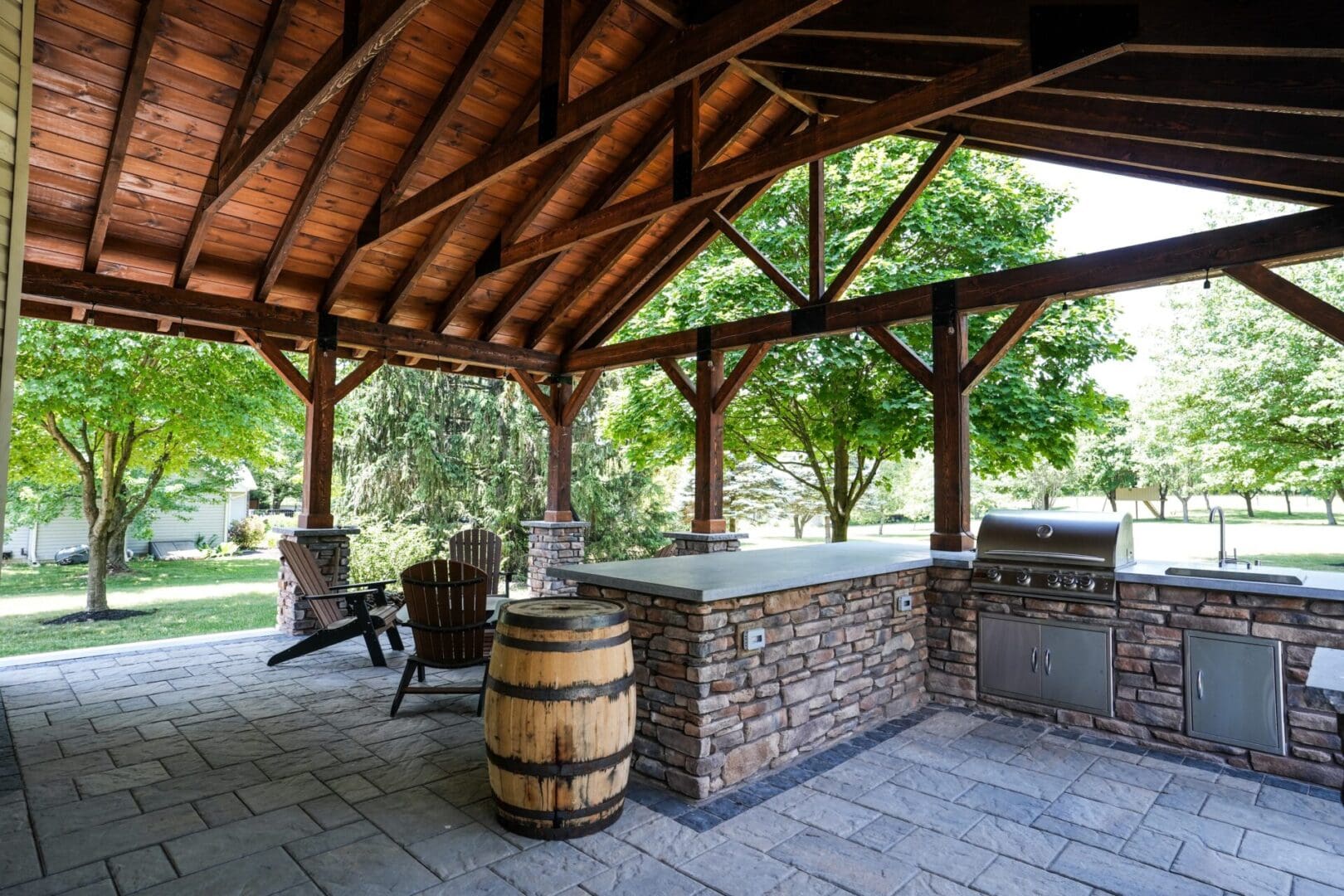 A custom outdoor kitchen with a fireplace and bbq.