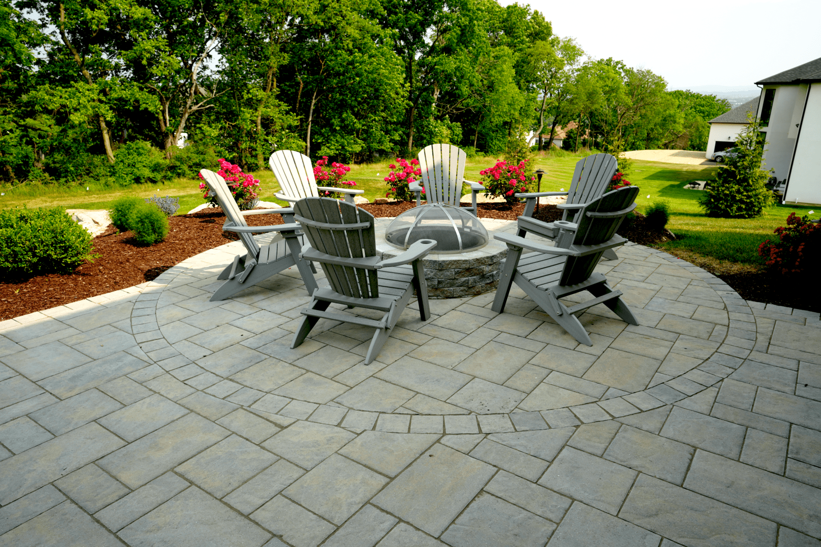 A patio with chairs and a fire pit, perfect for Planting Professionals to unwind after a long day.