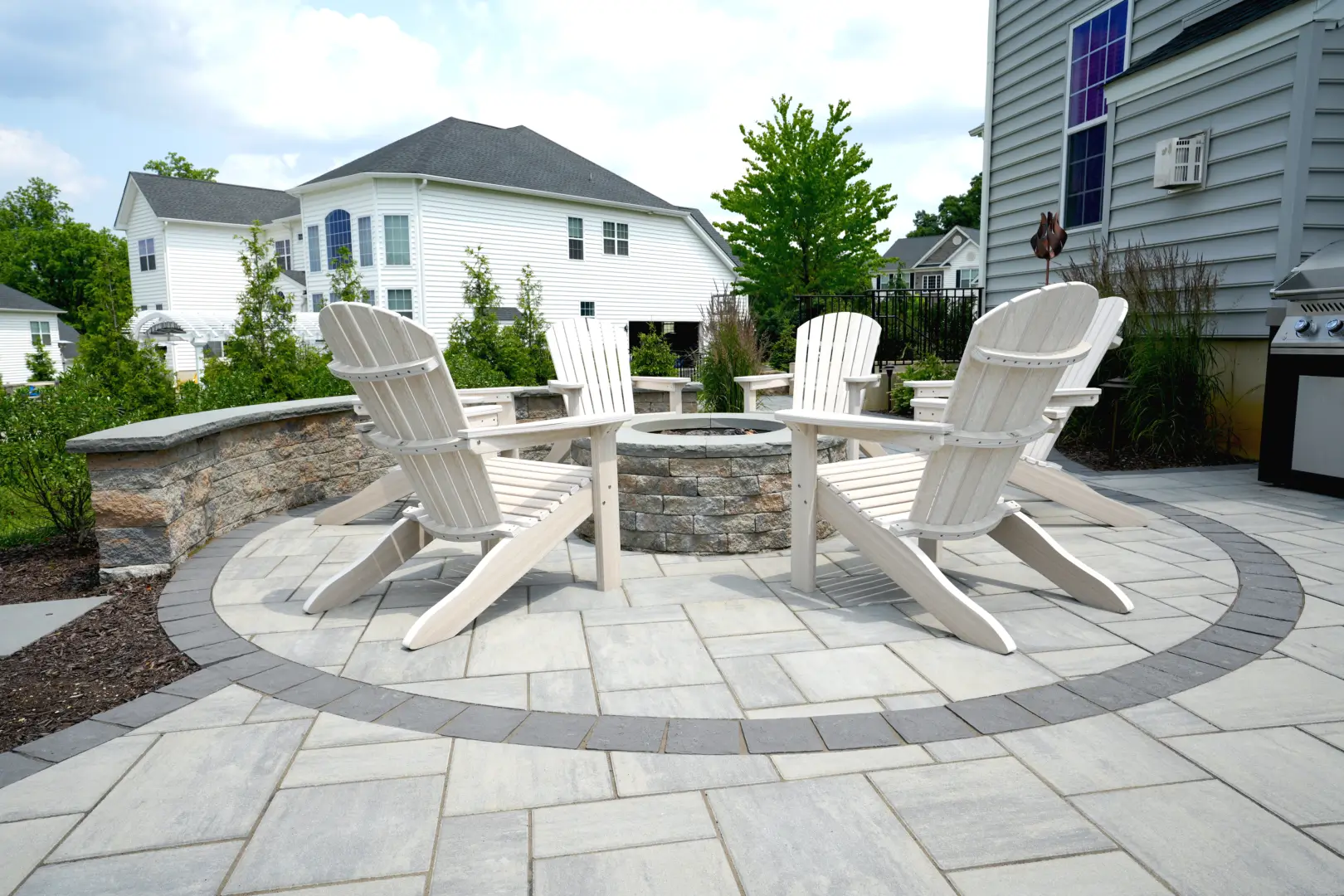 A custom patio with chairs and a fire pit.