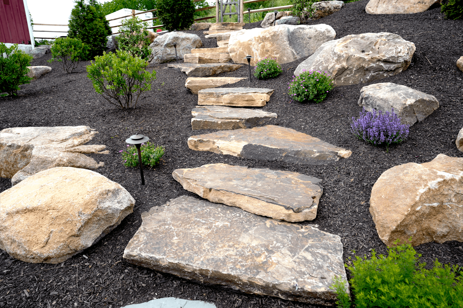 A boulder path leading to a garden.