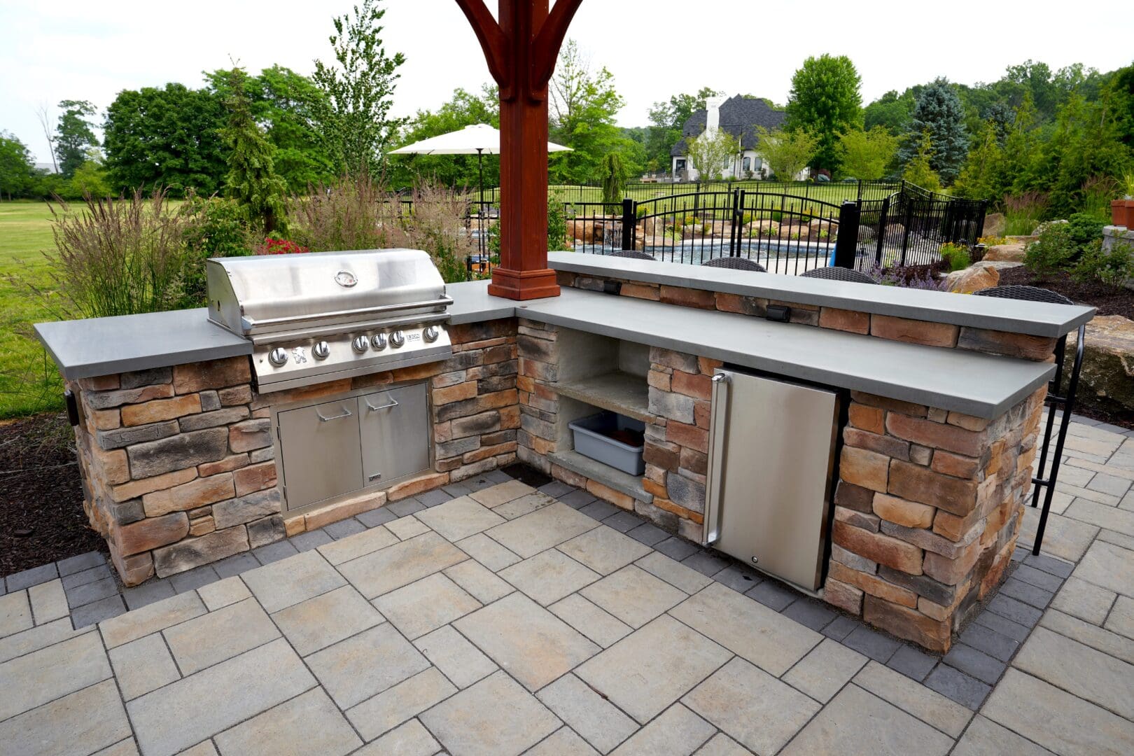 A custom outdoor kitchen featuring a grill and sink.