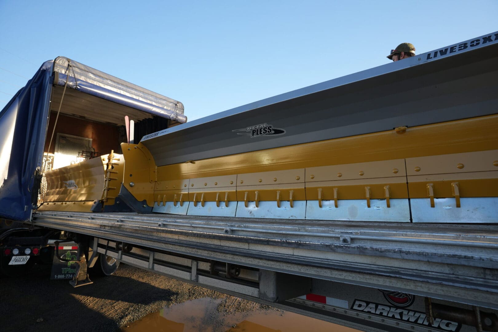 A large yellow machine is on the road.