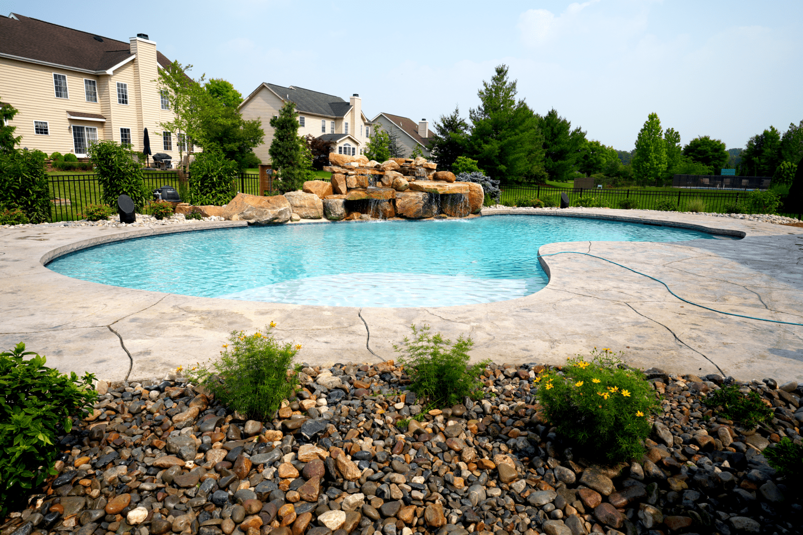 A pool with rocks and plants in the foreground.