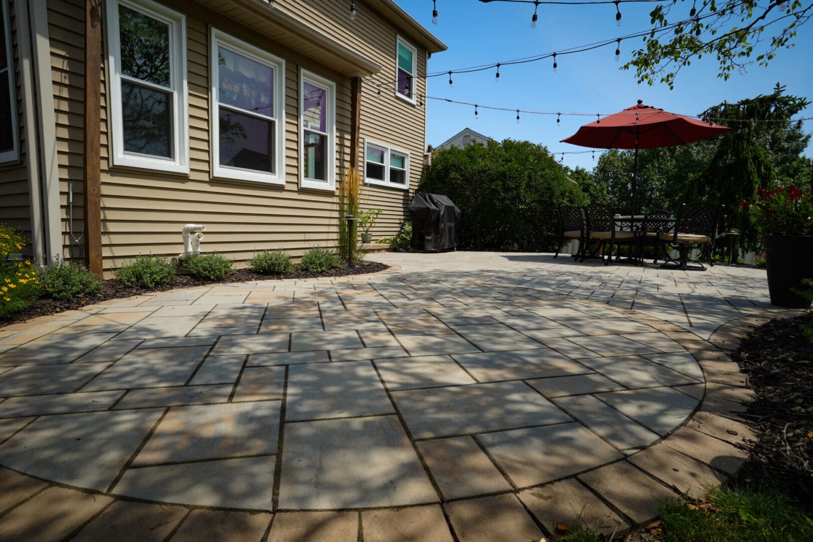 A patio with a table and chairs in the background.