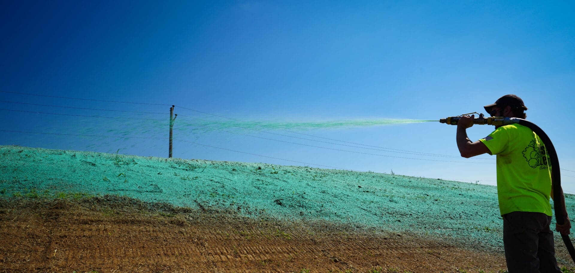 A green cloud is seen in the sky above a field.