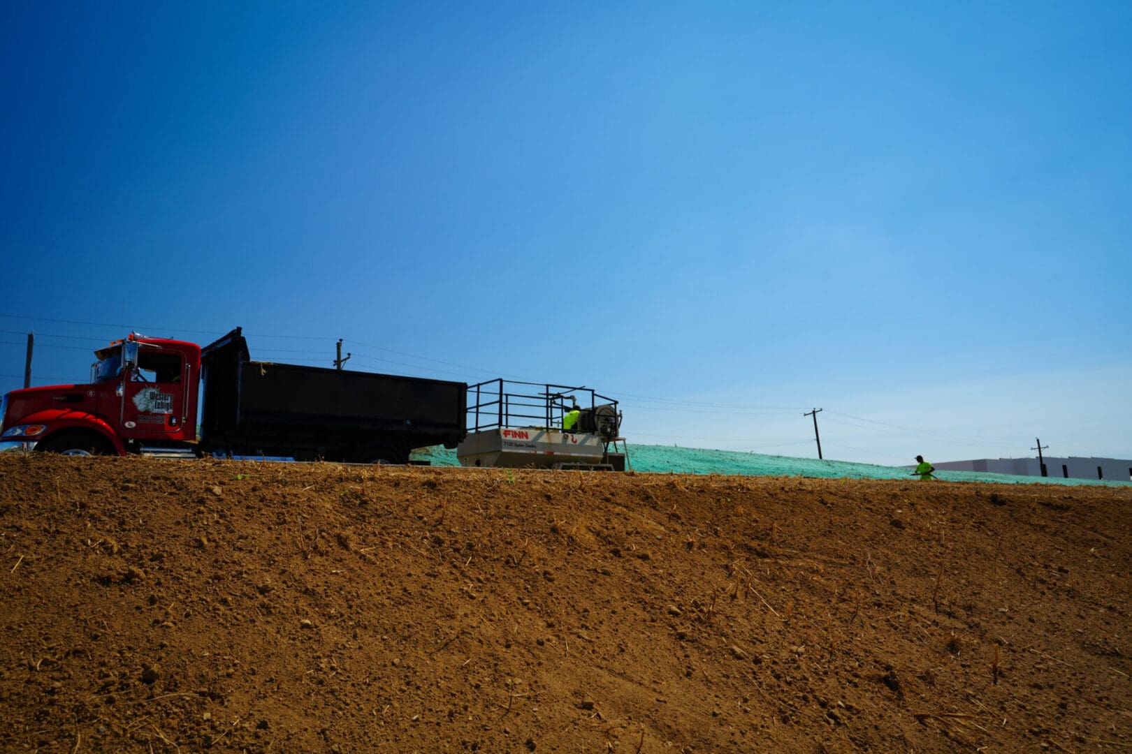 A tractor is on the side of a hill.