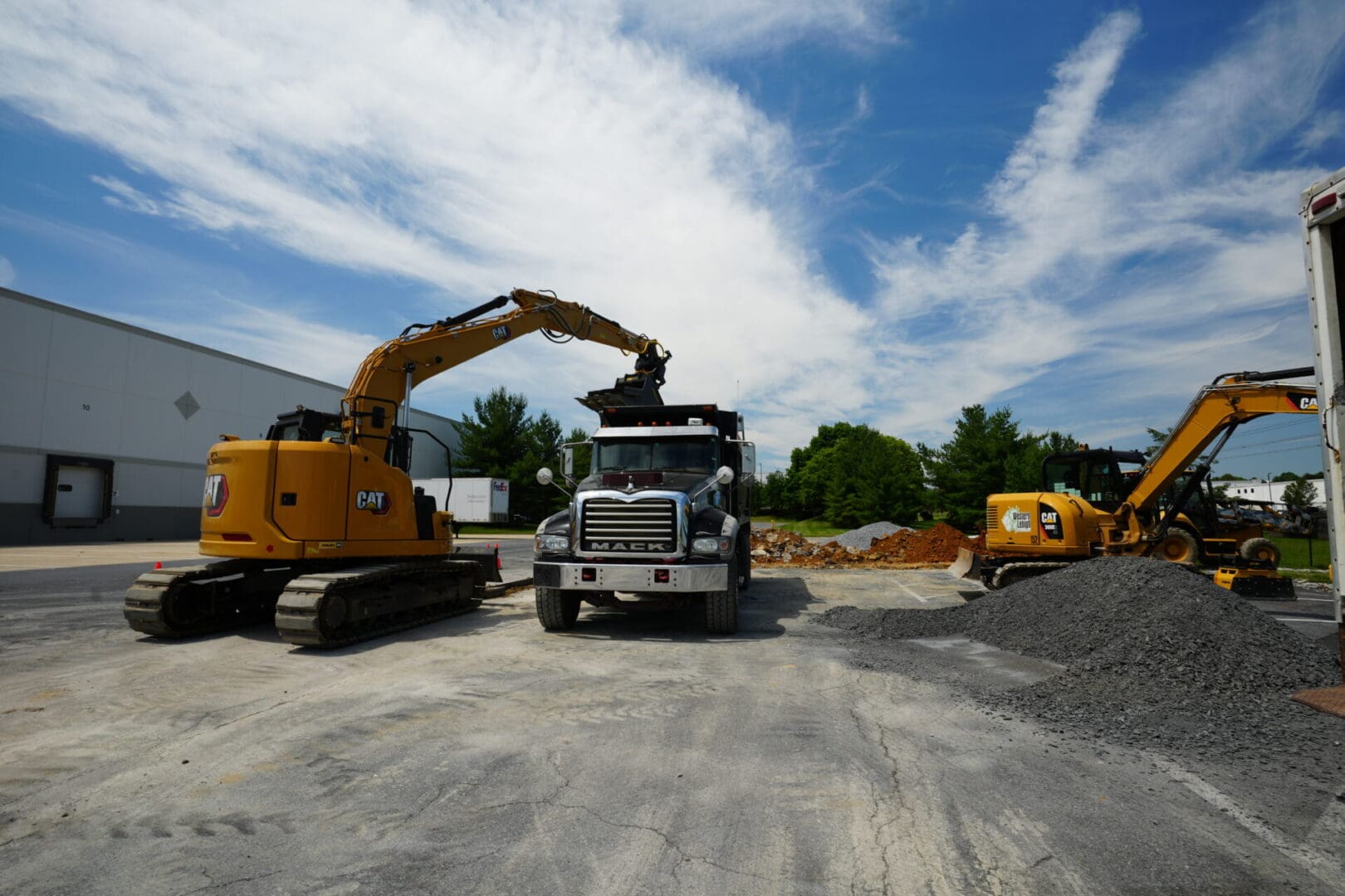 A construction truck is parked in the middle of a lot.