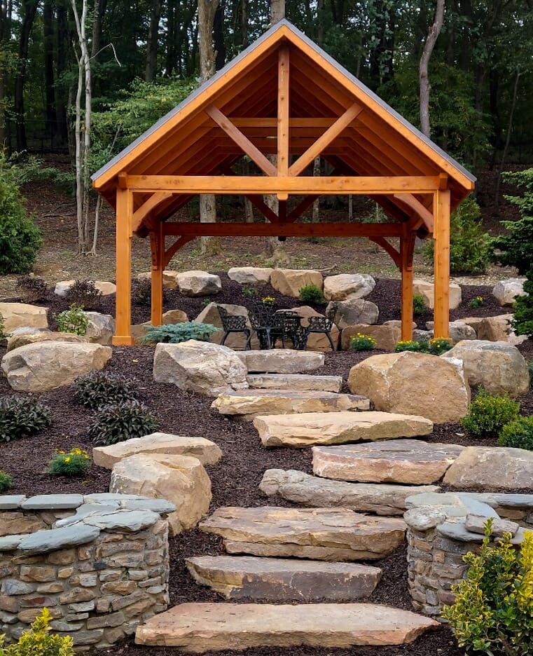 A wooden structure sitting in the middle of a garden.