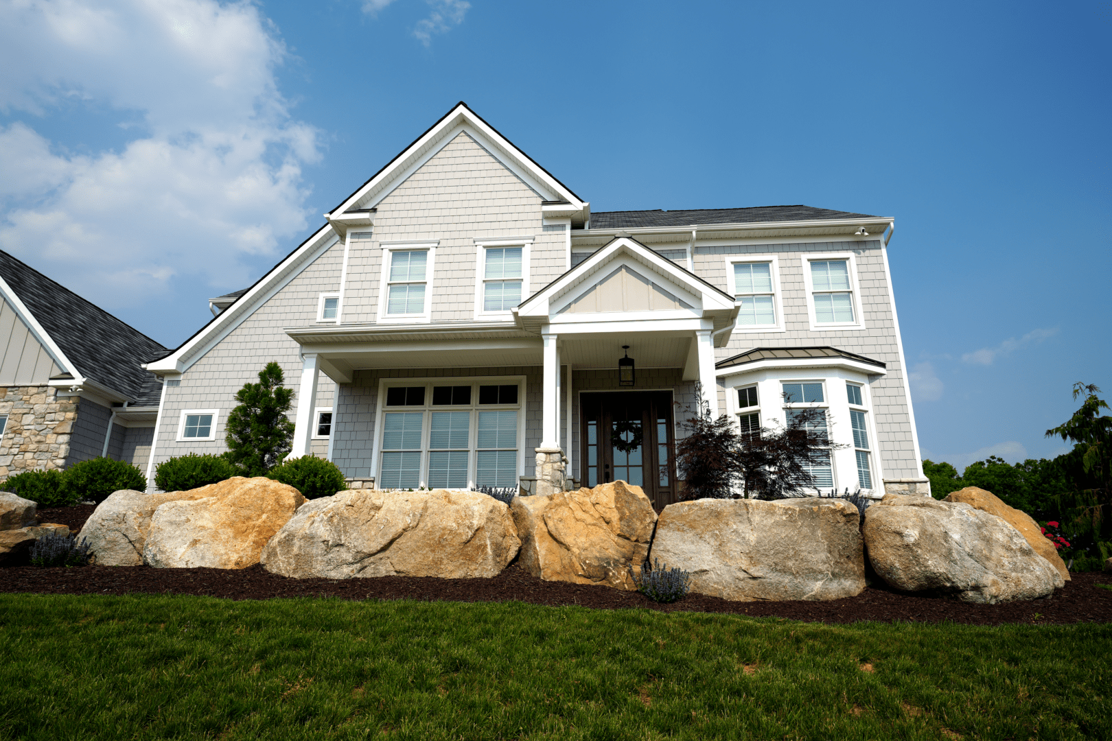 A large white house sitting on top of a hill.