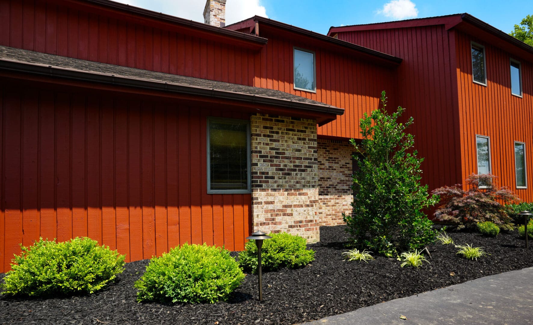 A red house with brick and stone accents.