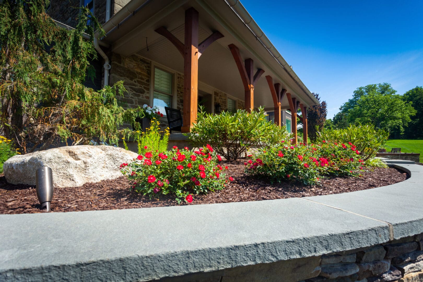 A building with flowers in the front yard.