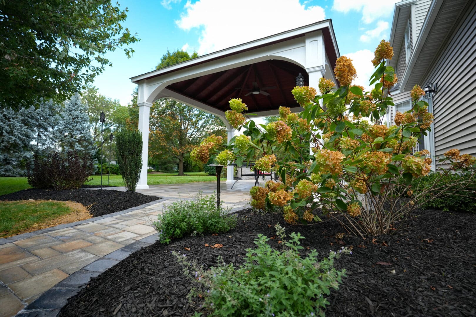 A gazebo with flowers in the middle of it