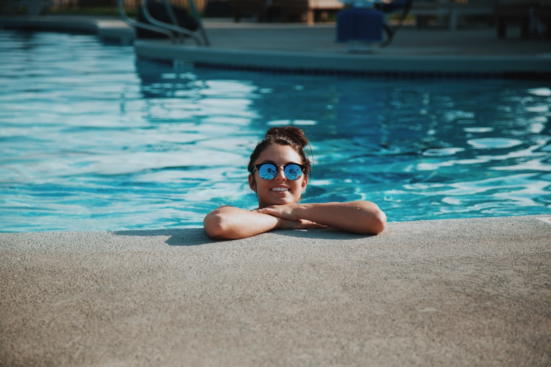 Woman in in the ground pool smiling
